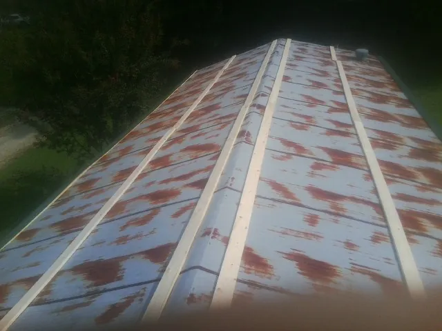Rusted metal roof panels with new wood purlins before replacement — Storm Damage Roof Repair in Jakin by Roofing Brothers